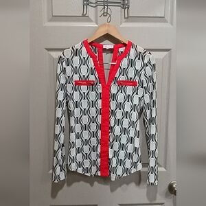 Red, black and white geometric print blouse with a red V-neck trim by A'GACI EUC